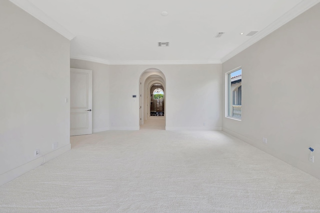 unfurnished room with crown molding and light carpet