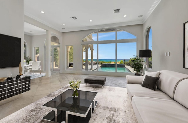 tiled living room featuring a water view and ornamental molding