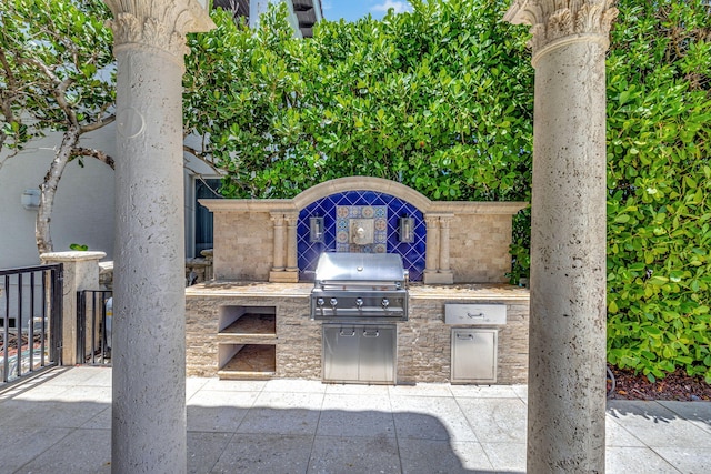 view of patio with area for grilling and exterior kitchen