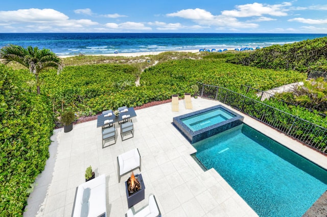 view of swimming pool featuring a patio area, an in ground hot tub, and a water view