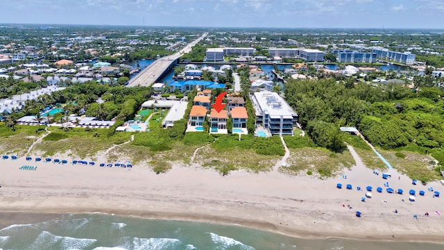 aerial view with a water view and a beach view