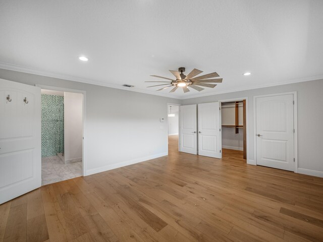 unfurnished bedroom featuring ceiling fan, light wood-type flooring, and ornamental molding