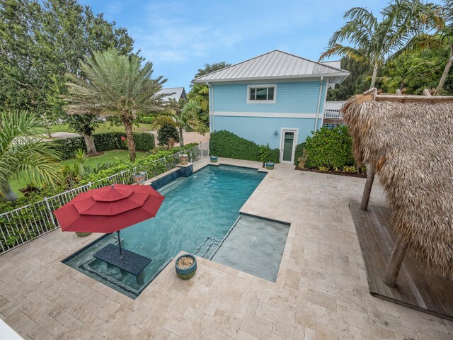 view of pool featuring a patio area and a hot tub