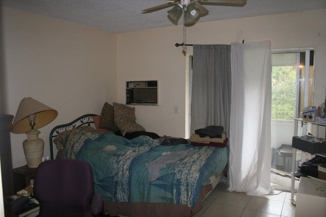 tiled bedroom with ceiling fan, a textured ceiling, and a wall mounted AC