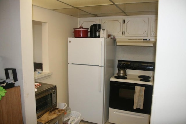 kitchen with a paneled ceiling, range hood, white cabinets, and white appliances