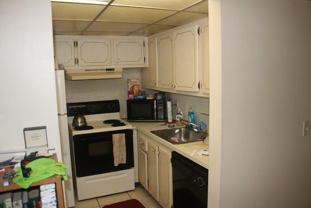 kitchen featuring a paneled ceiling, black appliances, sink, light tile patterned floors, and range hood