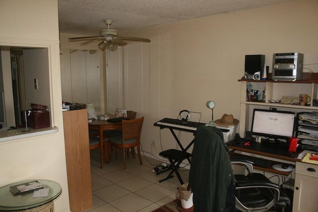 tiled home office featuring a textured ceiling and ceiling fan