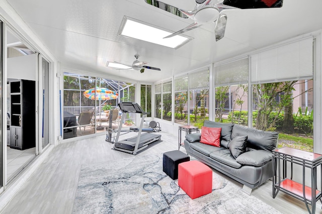 sunroom with a skylight and ceiling fan