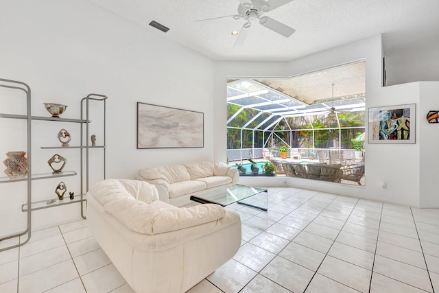 tiled living room featuring a textured ceiling and ceiling fan