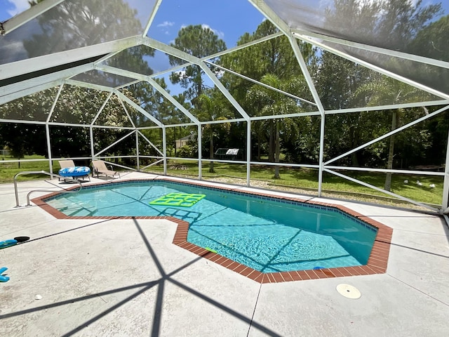 view of swimming pool featuring a lanai, a patio area, and a lawn