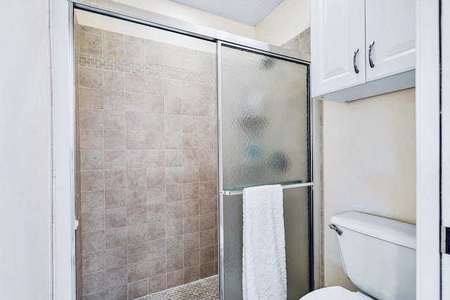 bathroom with an enclosed shower and toilet