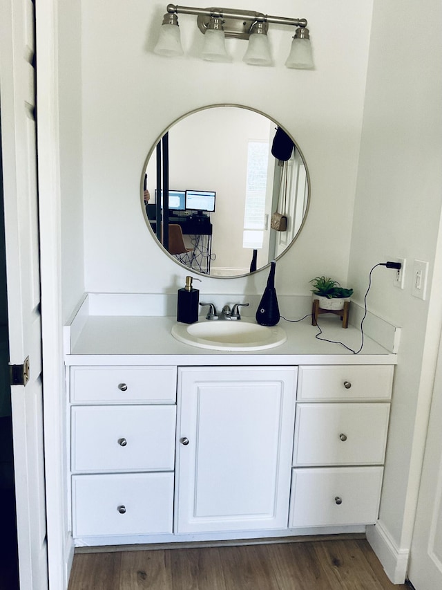 bathroom featuring hardwood / wood-style flooring and vanity