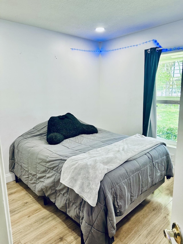 bedroom with light hardwood / wood-style flooring