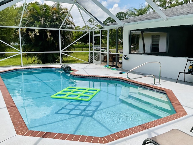 view of swimming pool with a lanai and a patio