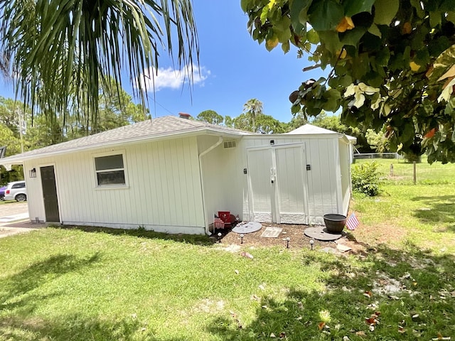 view of outbuilding with a lawn