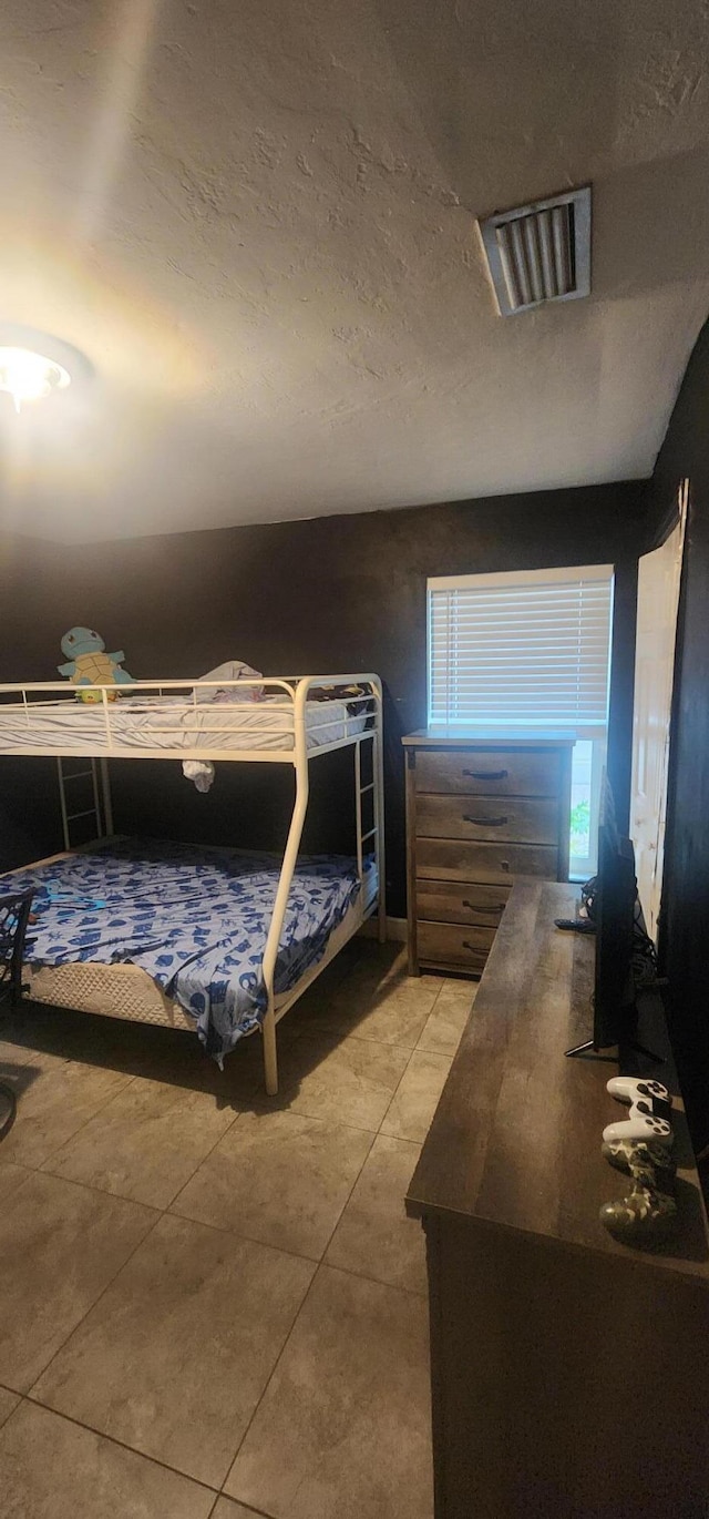 bedroom featuring tile patterned flooring