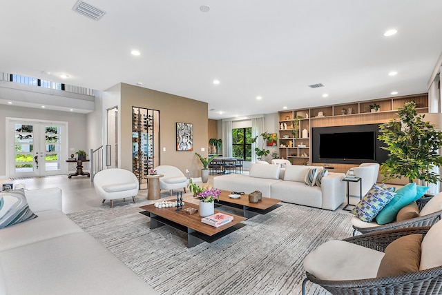 living room featuring built in features and french doors