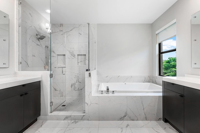 bathroom featuring vanity and independent shower and bath