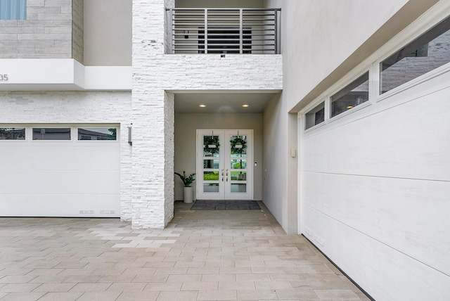 entrance to property with a garage and french doors