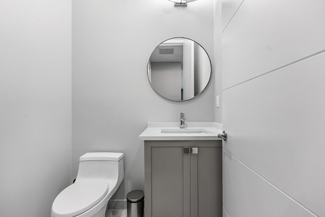 bathroom featuring toilet and vanity