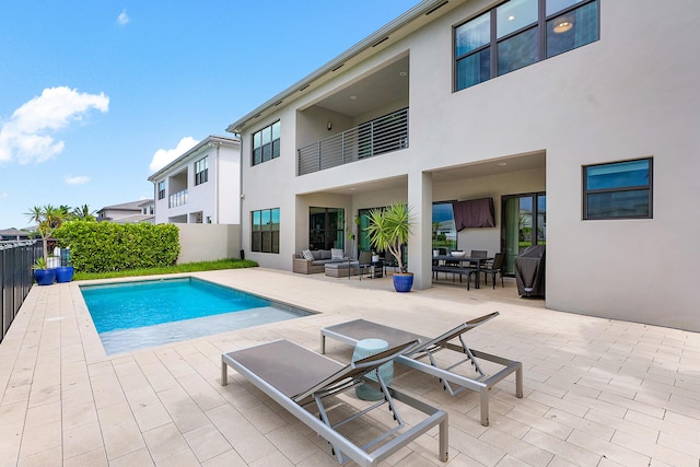 view of swimming pool featuring a patio area and an outdoor living space