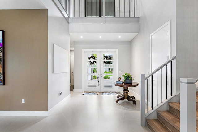 entrance foyer with a high ceiling and french doors