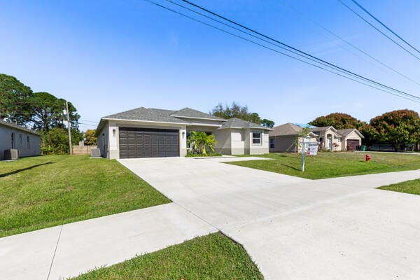 1317 SW Paar Dr, Port Saint Lucie, FL 34953 - ranch-style house featuring a garage and a front lawn