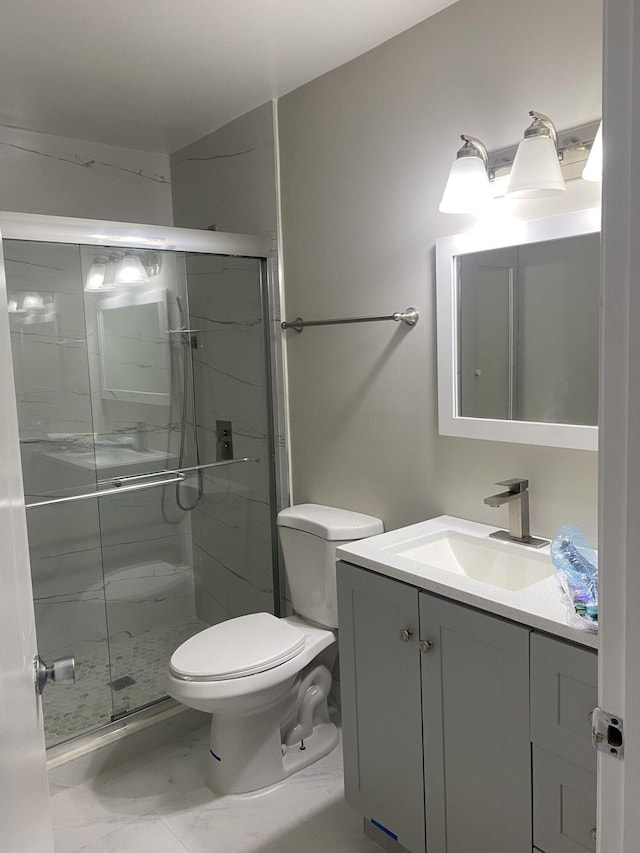 bathroom with vanity, walk in shower, tile patterned flooring, and toilet