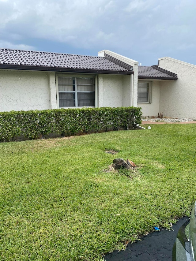 view of home's exterior with a yard