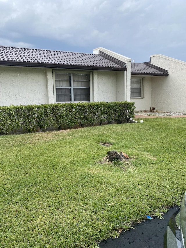 view of property exterior with a yard