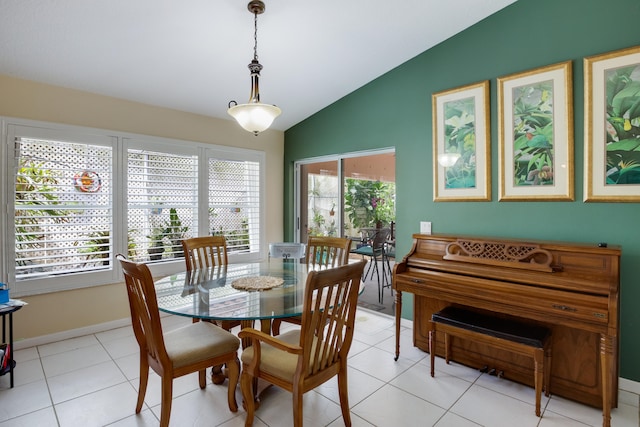 tiled dining area with plenty of natural light and vaulted ceiling