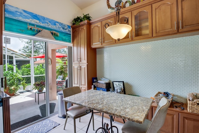 tiled dining area with lofted ceiling