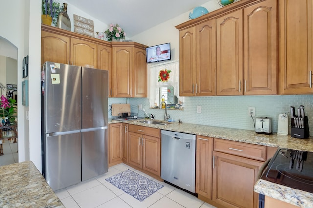 kitchen featuring light tile patterned floors, tasteful backsplash, appliances with stainless steel finishes, and sink