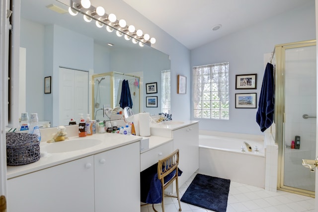 bathroom with independent shower and bath, tile patterned floors, and vanity