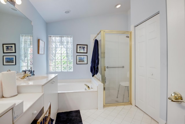 bathroom featuring vanity, shower with separate bathtub, and tile patterned flooring