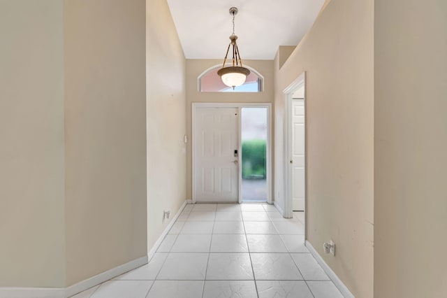 entryway featuring light tile patterned floors and baseboards