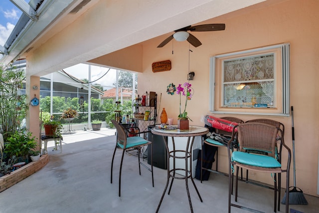 view of patio / terrace with ceiling fan and glass enclosure