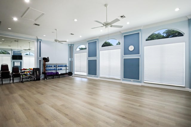 living room with light hardwood / wood-style floors, crown molding, and ceiling fan