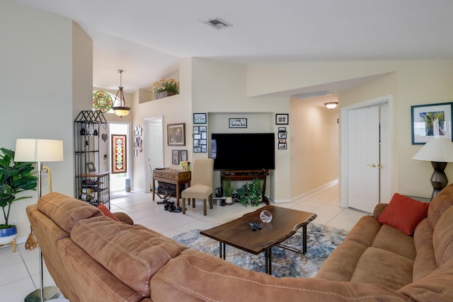 living room featuring light tile patterned floors and high vaulted ceiling