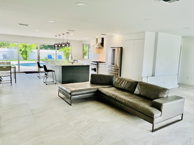 living room with sink and a chandelier