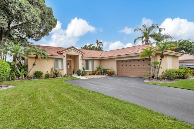 view of front of house featuring a front lawn and a garage