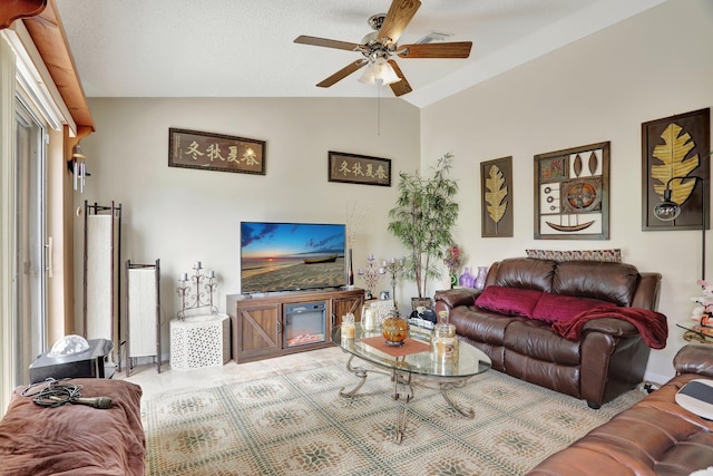 tiled living room featuring ceiling fan and vaulted ceiling