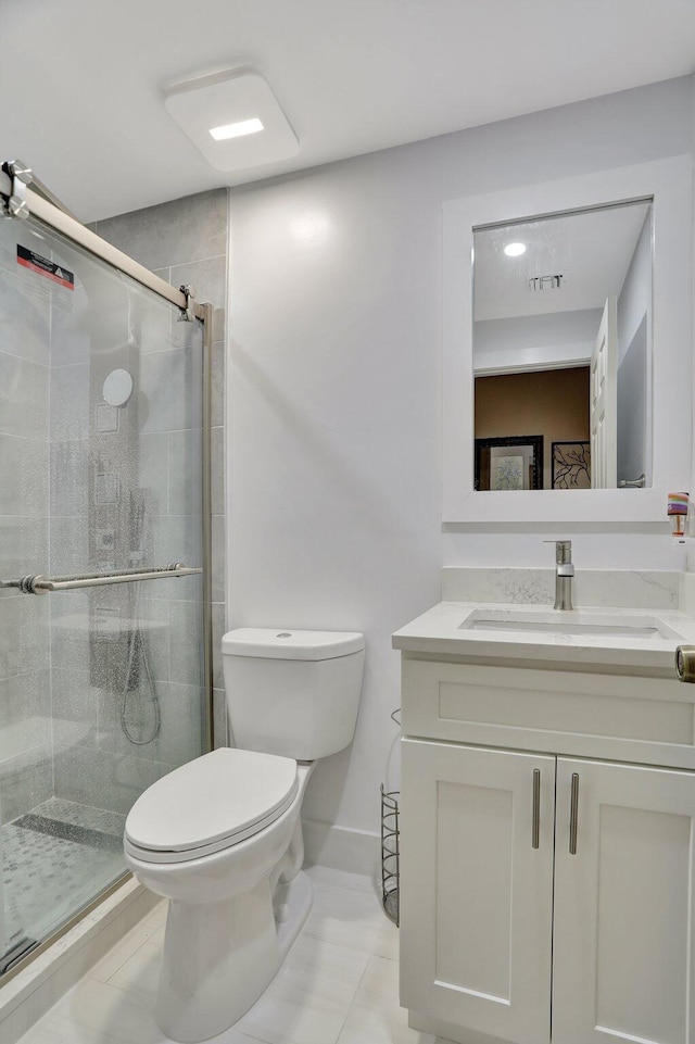 bathroom featuring tile patterned floors, vanity, walk in shower, and toilet