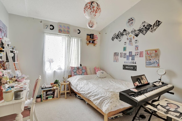 bedroom with a textured ceiling and carpet flooring