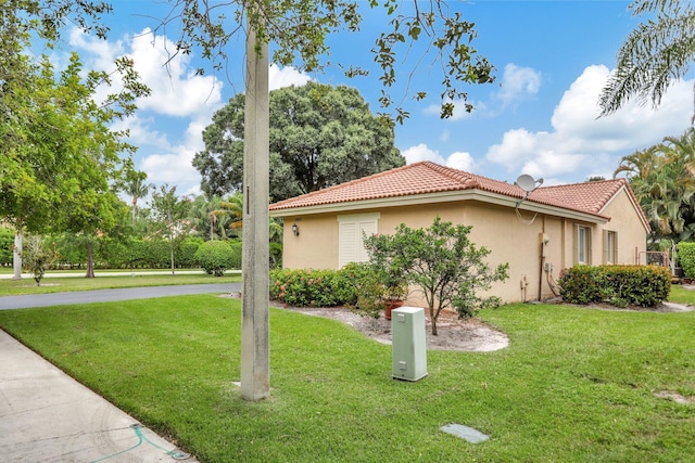 view of property exterior with a yard