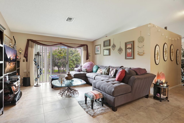 living room featuring light tile patterned floors and a textured ceiling