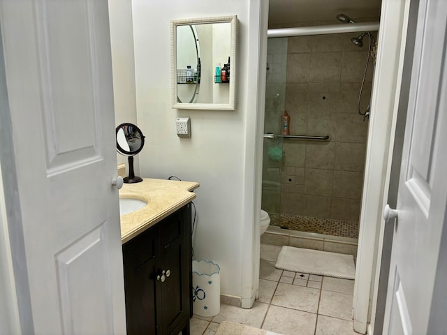 bathroom with vanity, walk in shower, tile patterned flooring, and toilet