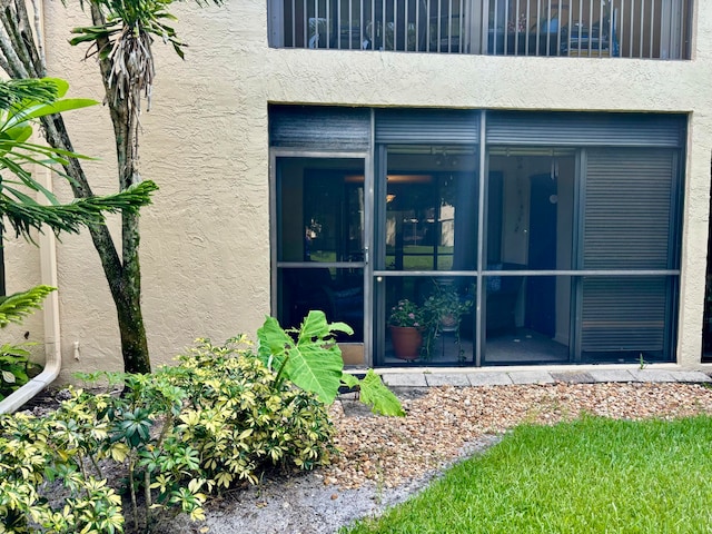 exterior space featuring a balcony and a sunroom