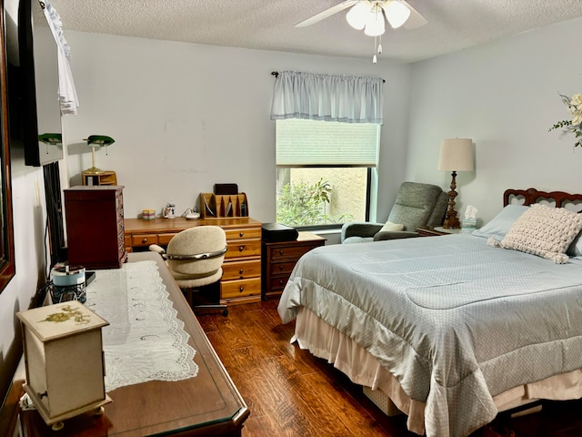 bedroom featuring dark hardwood / wood-style flooring, a textured ceiling, and ceiling fan