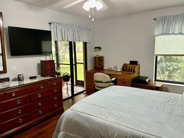 bedroom with dark wood-style floors, access to outside, a textured ceiling, and a ceiling fan